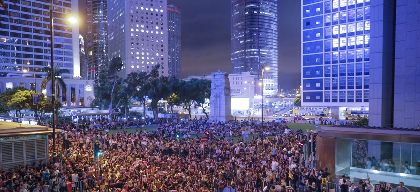 Pro-democracy protesters gather to participate in a rally organized by higher education students in Chater Garden in Hong Kong Friday, Aug. 16, 2019.