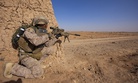 U.S. Marine Cpl. Dennis Cox, a scout sniper assigned to 1st Battalion, 9th Marine Regiment, Regional Command (Southwest), inches closer to the edge of a dirt wall during an interdiction operation in Helmand province, Afghanistan, Dec. 19, 2013. 