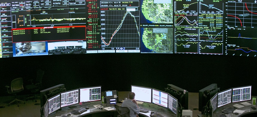 In this 2017 photo, electrical power flow and conditions are monitored at the California Independent System Operator grid control center, in Folsom, Calif.