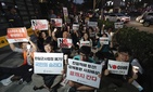 South Korean protesters react during a rally about the General Security of Military Information Agreement, or GSOMIA, in front of Japanese embassy in Seoul, South Korea, Thursday, Aug. 22, 2019. South Korean protesters react during a rally about the General Security of Military Information Agreement, or GSOMIA, in front of Japanese embassy in Seoul, South Korea, Thursday, Aug. 22, 2019.