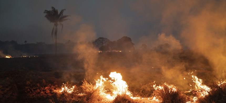 A fire burns a field on a farm in the Nova Santa Helena municipality, in the state of Mato Grosso, Brazil, Friday, Aug. 23, 2019.