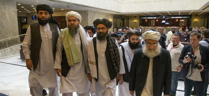 Mullah Abdul Ghani Baradar, the Taliban group's top political leader, third from left, arrives with other members of the Taliban delegation for talks in Moscow, Russia