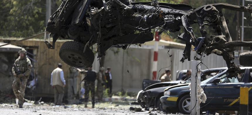 Resolute Support (RS) forces remove a destroyed vehicle after a car bomb explosion in Kabul, Afghanistan, Thursday, Sept. 5, 2019.