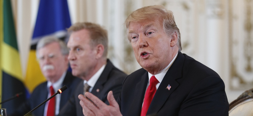 From left, National Security Adviser John Bolton, Acting Defense Secretary Patrick Shanahan, and President Donald Trump sit together during a meeting with Caribbean leaders at Mar-A Lago, Friday, March 22, 2019, in Palm Beach, Fla.