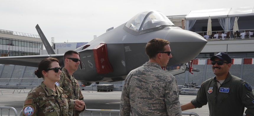 U.S Air Force crew members gather next to a F-35 Lightning II at Paris Air Show, in Le Bourget, east of Paris, France, Tuesday, June 18, 2019.