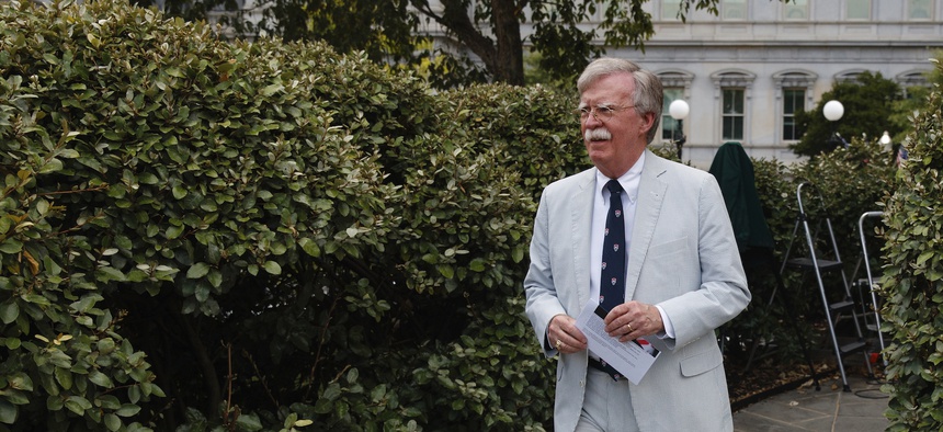 National security adviser John Bolton walks to speak to media at the White House in Washington, Wednesday, July 31, 2019.