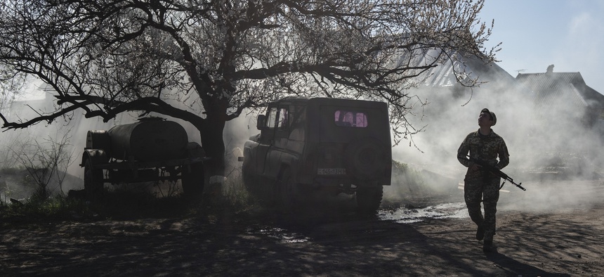 In this Saturday, April 20, 2019 file photo, a Ukrainian serviceman guards a position near the frontline as the conflict continues, in Mariinka, Donetsk region, eastern Ukraine.
