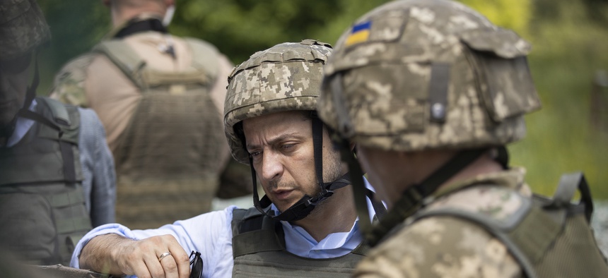 Ukrainian President Volodymyr Zelenskiy talks with servicemen as he visits the war-hit Luhansk region, eastern Ukraine, Monday, May 27, 2019.