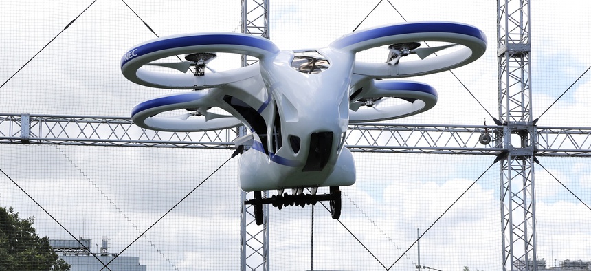 NEC Corp.'s machine with propellers hovers at the company's facility in Abiko near Tokyo, Monday, Aug. 5, 2019. The Japanese electronics maker showed a "flying car," a large drone-like machine with four propellers that hovered steadily for about a minute.