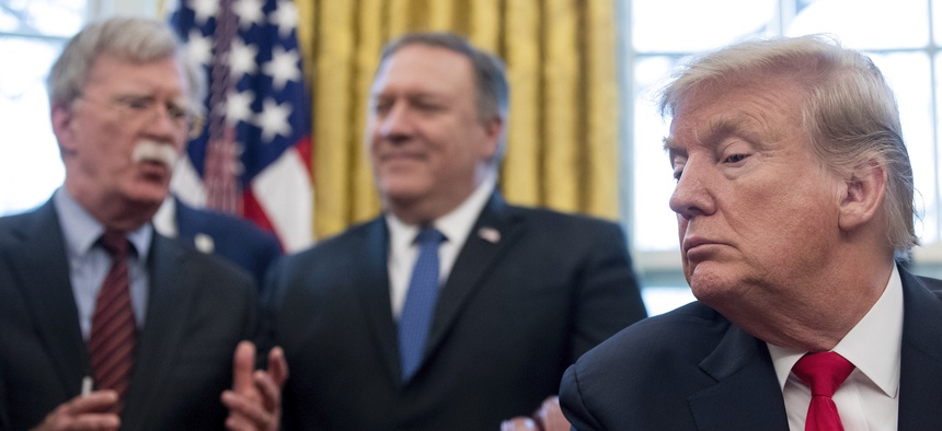 From left, National Security Adviser John Bolton, accompanied by Secretary of State Mike Pompeo, and President Donald Trump, at the White House in Washington, Thursday, Feb. 7, 2019.