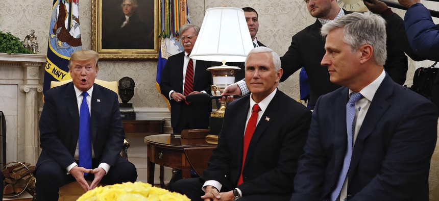 Then-presidential envoy Robert O'Brien, right, attends an Oval Office press conference with President Donald Trump in March 2019. At back, to the right of Trump, is national security adviser John Bolton.