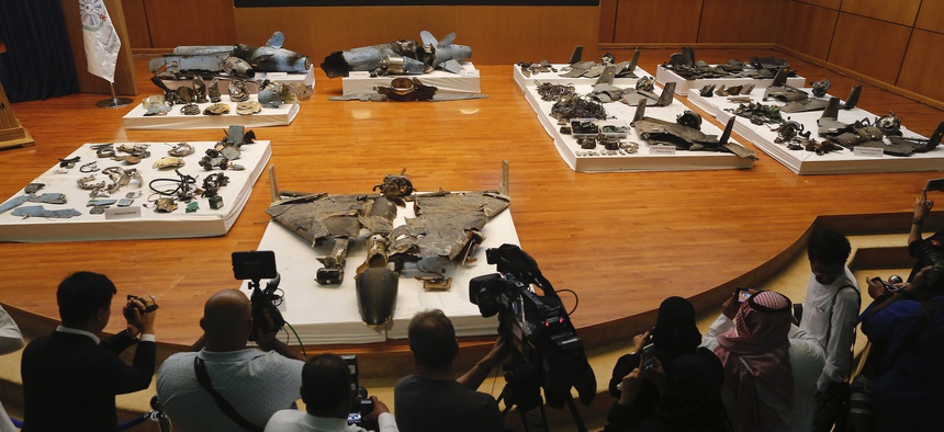 Journalists film what Saudi military spokesman Col. Turki al-Malki said was evidence of Iranian weaponry used in the attack targeted Saudi Aramco's facilities in Abqaiq and Khurais, during a press conference in Riyadh, Saudi Arabia.