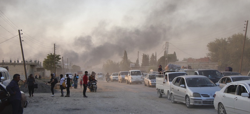 Syrians flee shelling by Turkish forces in Ras al Ayn, northeast Syria, Wednesday, Oct. 9, 2019.