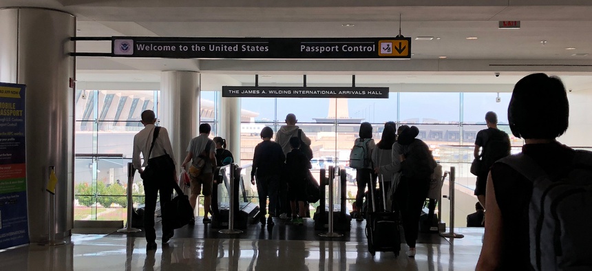 Passengers head for U.S. passport control at Dulles International Airport in a 2018 photo.