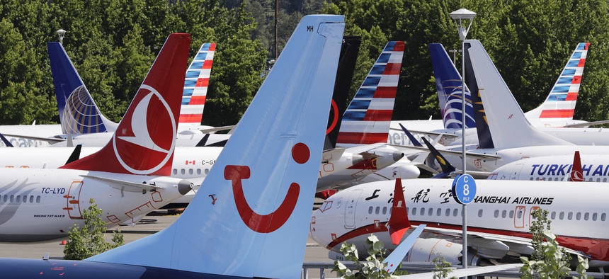 Dozens of grounded Boeing 737 MAX airplanes, including one for TUI Airlines, center, crowd a parking area adjacent to Boeing Field Thursday, Aug. 15, 2019, in Seattle, Washington.