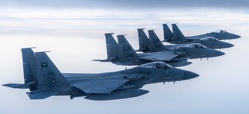 Royal Saudi Air Force F-15C Eagles fly in formation with U.S. Air Force F-15Cs in the Middle East.