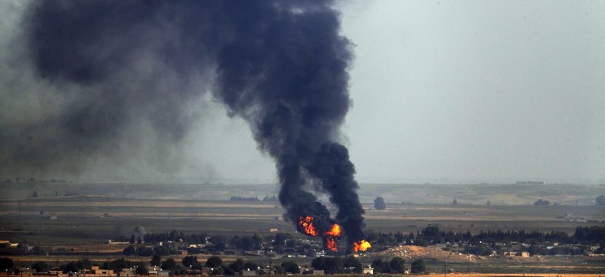 In this photo taken from southeastern Turkey, flames and smoke billow from a fire on a target in Ras al-Ayn, Syria, caused by shelling by Turkish forces, Thursday, Oct. 17, 2019.