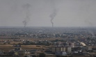 A hilltop in Ceylanpinar, Sanliurfa province, southeastern Turkey, overlooks smoke billowing from fires in Ras al-Ayn, Syria, Sunday, Oct. 20, 2019.