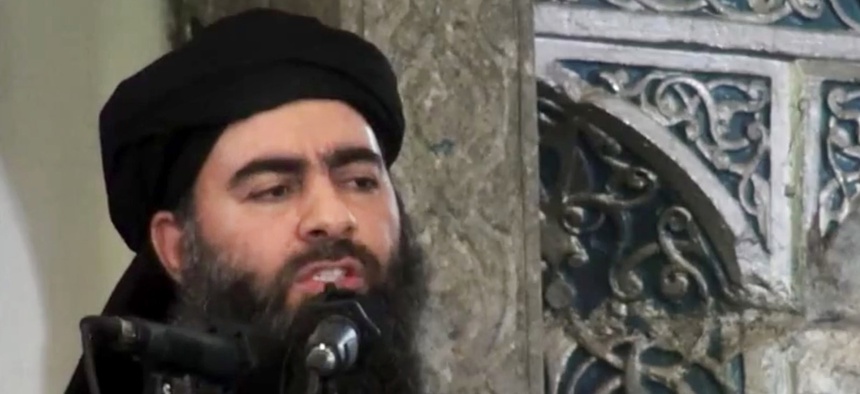 This file image made from video posted on a militant website Saturday, July 5, 2014, purports to show the leader of the Islamic State group, Abu Bakr al-Baghdadi, delivering a sermon at a mosque in Iraq during his first public appearance.