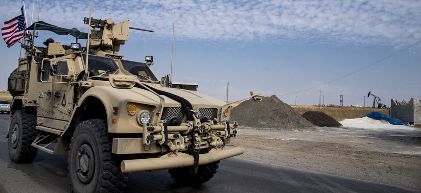 In this Monday, Oct. 28, 2019 photo, U.S. forces patrol Syrian oil fields. Pentagon is increasing U.S. efforts to protect Syria's oil fields from the extremist group as well as from Syria itself and the country's Russian allies.