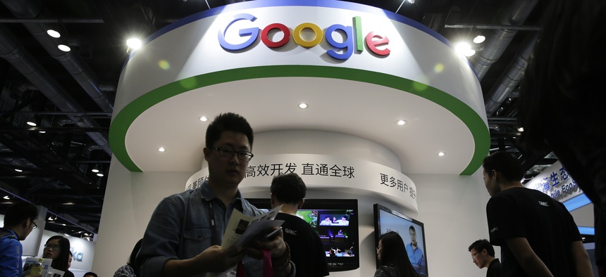 In this April 28, 2016, file photo, visitors gather at a display booth for Google at the 2016 Global Mobile Internet Conference (GMIC) in Beijing.