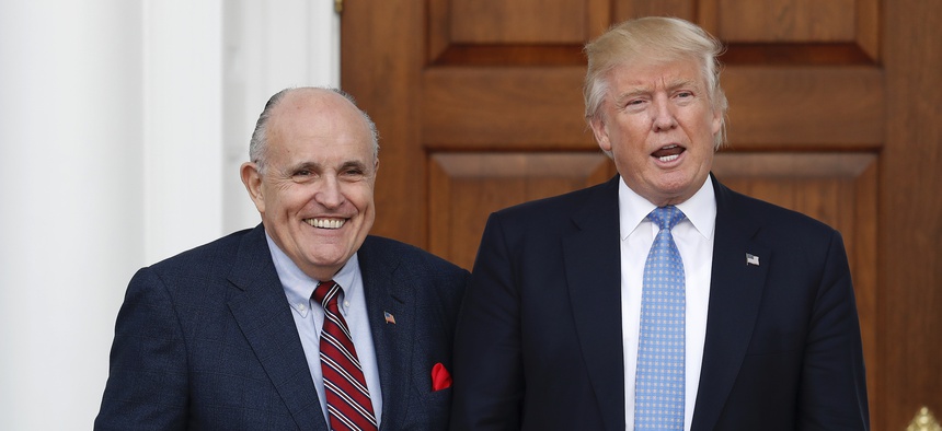 President-elect Donald Trump calls out to media as he and former New York Mayor Rudy Giuliani pose for photographs as Giuliani arrives at the Trump National Golf Club Bedminster clubhouse, Sunday, Nov. 20, 2016, in Bedminster, N.J.