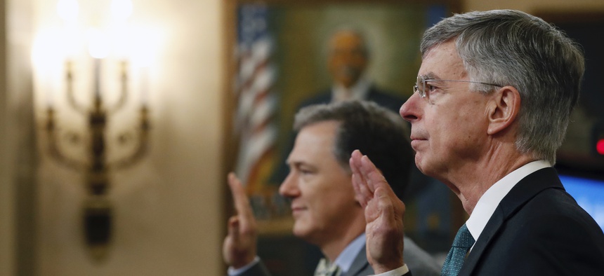 Top U.S. diplomat in Ukraine William Taylor, right, and career Foreign Service officer George Kent, left are sworn in to testify before the House Intelligence Committee on Capitol Hill in Washington, Wednesday, Nov. 13, 2019.