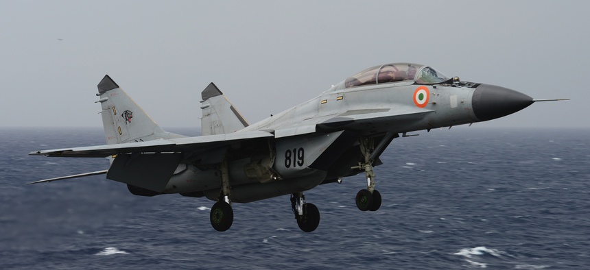 An Indian navy MIG-29K "Fulcrum" flies over the aircraft carrier USS Nimitz (CVN 68) during Exercise Malabar 2017.