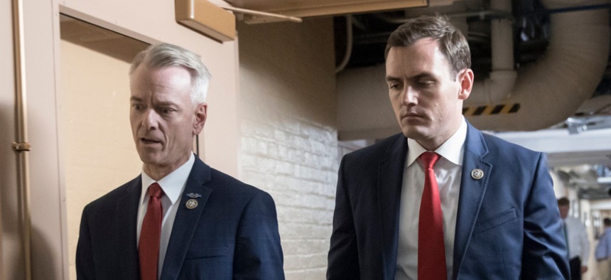 Rep. Mike Gallagher, R-Wis., walks through the Capitol with Rep. Steve Russell, R-Okla.