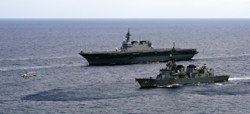 In this June 28, 2019, photo, Japan's Maritime Self-Defense Force helicopter carrier Izumo (DDH-183) and destroyer JS Murasame (DD-101) participate in drills that included maritime navigation and emergency response exercises in Sulu Sea.