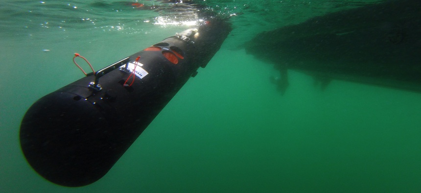U.S. and Italian sailors deploy a Remote Environmental Measuring Units (REMUS) 100 unmanned underwater vehicle off Sesimbra, Portugal, Sept. 19, 2019.
