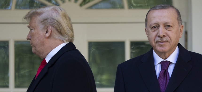 President Donald Trump walks off toward the Oval Office after posing for photographers with Turkish President Recep Tayyip Erdogan before a meeting in the Oval Office of the White House, Wednesday, Nov. 13, 2019.