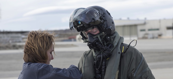 Marine Corps Maj. Douglas Rosenstock, 461st Flight Test Squadron, is inspected by contractor Dr. Angela Theys during a chemical/biological pilot ensemble test Jan. 6 at Edwards Air Force Base, California.