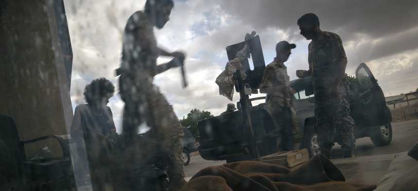 In this Saturday Sept. 7, 2019 photo, fighters of the 'Shelba' unit, allied with the U.N.-supported Libyan government, prepare for combat at the Salah-addin neighborhood front line in Tripoli, Libya.