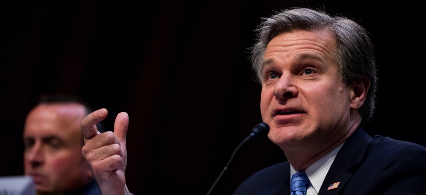 FBI Director Christopher Wray, accompanied by Homeland Security Under Secretary for Intelligence and Analysis David Glawe, left, testifies before a Senate Homeland Security Committee hearing on Capitol Hill in Washington, Tuesday, Nov. 5, 2019.