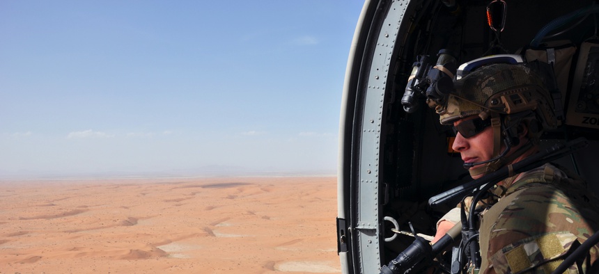 Capt. John Conner, an Air Force combat rescue officer from the 64th Expeditionary Rescue Squadron, flies with an Army National Guard UH-60 Blackhawk helicopter crew over Kandahar, Afghanistan, during joint training April 5, 2019.