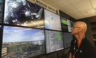 n this Wednesday, July 18, 2018 photo, National Weather Service forecaster Marvin Percha reviews monitors that track satellite and Doppler radar images, as well as his colleagues' forecasts posted on social media, at Tempe, AZ.