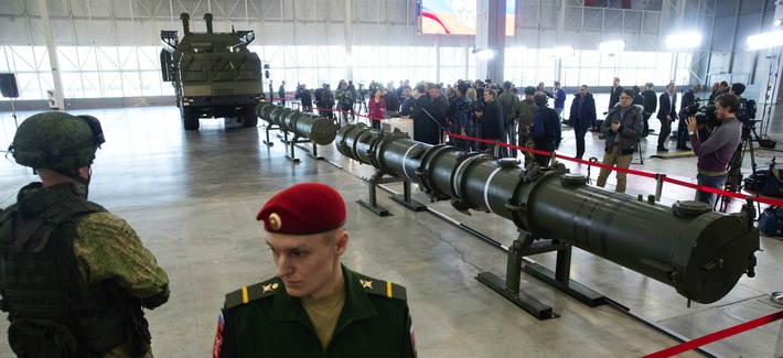 Russian military officers stand by as the 9M729, center, its launcher, left, and the 9M728, right, land-based cruise missiles are displayed in Kubinka outside Moscow, Russia.