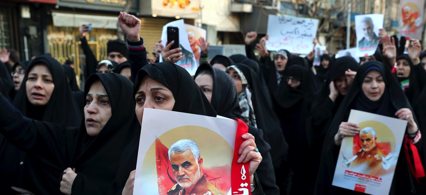Protesters chant slogans while holding up posters of Gen. Qassem Soleimani during a demonstration in front of the British Embassy in Tehran, Iran, Sunday, Jan. 12, 2020.