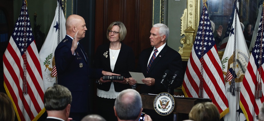 Vice President Mike Pence, right, swears in Air Force General John Raymond as Chief of Space Operations, as his wife, Molly, center, holds a bible in the Ceremonial office at the Executive Office Building, Tuesday, Jan. 14, 2020, in Washington.