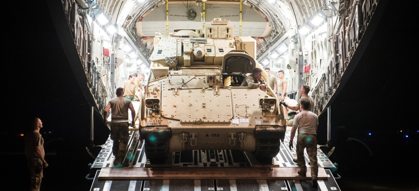 An M2 Bradley Fighting Vehicle is loaded onto a U.S. Air Force C-17 Globemaster III at Ali Al Salem Air Base, Kuwait, Oct. 30, 2019.