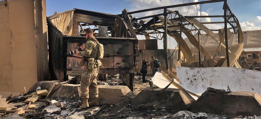 U.S. soldiers inspect rubble at a site of Iranian bombing, in Ain al-Asad air base, Anbar, Iraq, Monday, Jan. 13, 2020.