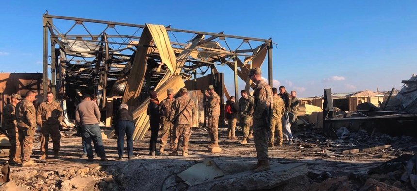 U.S. soldiers stand at a site of Iranian bombing at Ain al-Asad air base in Anbar, Iraq, Monday, Jan. 13, 2020.