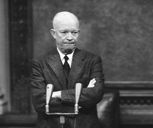 President Dwight Eisenhower, tight- lipped and standing with folded arms, is thoughtful in Washington, D.C., Jan. 19, 1956.