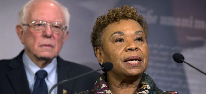 Rep. Barbara Lee, D-Calif., flanked by Sen. Bernie Sanders, I-Vt., speaks during a news conference on a measure limiting President Donald Trump's ability to take military action against Iran, on Capitol Hill, in Washington, Thursday, Jan. 9, 2020.