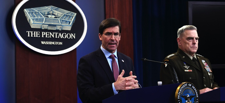 Defense Secretary Mark Esper, left, joined by Joint Chiefs​ Chairman Gen. Mark Milley, right, speaks during a news conference at the Pentagon in Washington, Friday, Dec. 20, 2019.