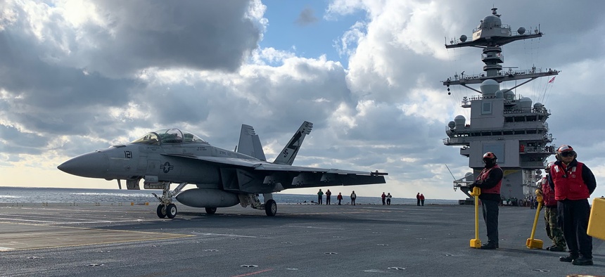 Crews ready an F/A-18 Super Hornet for take off on the deck of USS Gerald R. Ford on Monday Jan. 27.