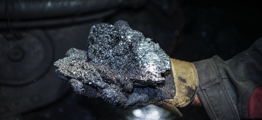 In this 2015 photo, a miner shows a lump of coal at one of the Krasnodonugol coal mines in Krasnodon, eastern Ukraine.