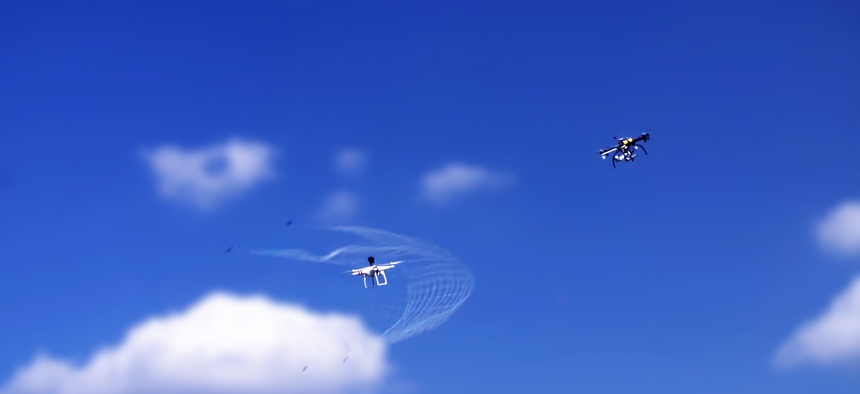 The Fortem Technologies DroneHunter deploying a net to capture a drone.