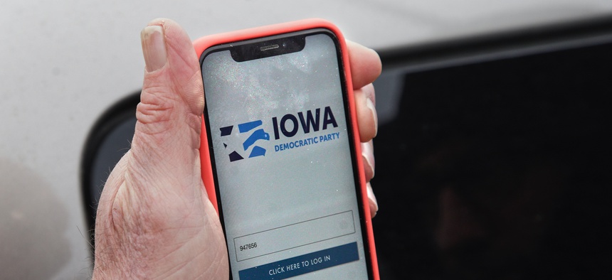 Precinct captain Carl Voss of Des Moines displays the Iowa Democratic Party caucus reporting app on his phone outside of the Iowa Democratic Party headquarters in Des Moines, Iowa, Tuesday, Feb. 4, 2020.